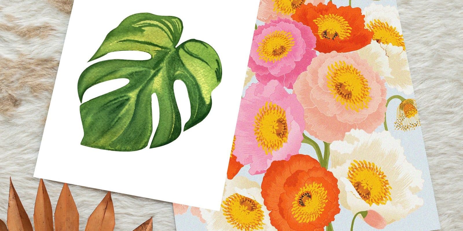 Two art prints, a watercolour monstera leaf and a field of poppies, overlapping on a cream cowhide rug