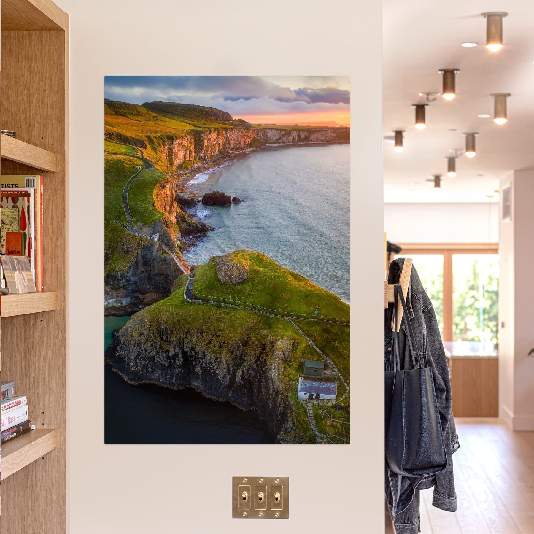 A large coastline print hanging in a bright hallway.