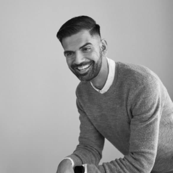 Nihar Kulkarni, smiling, in a black and white portrait.
